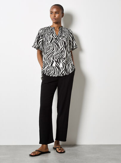 Zebra Swirl Tassel Tie Ruffle Top