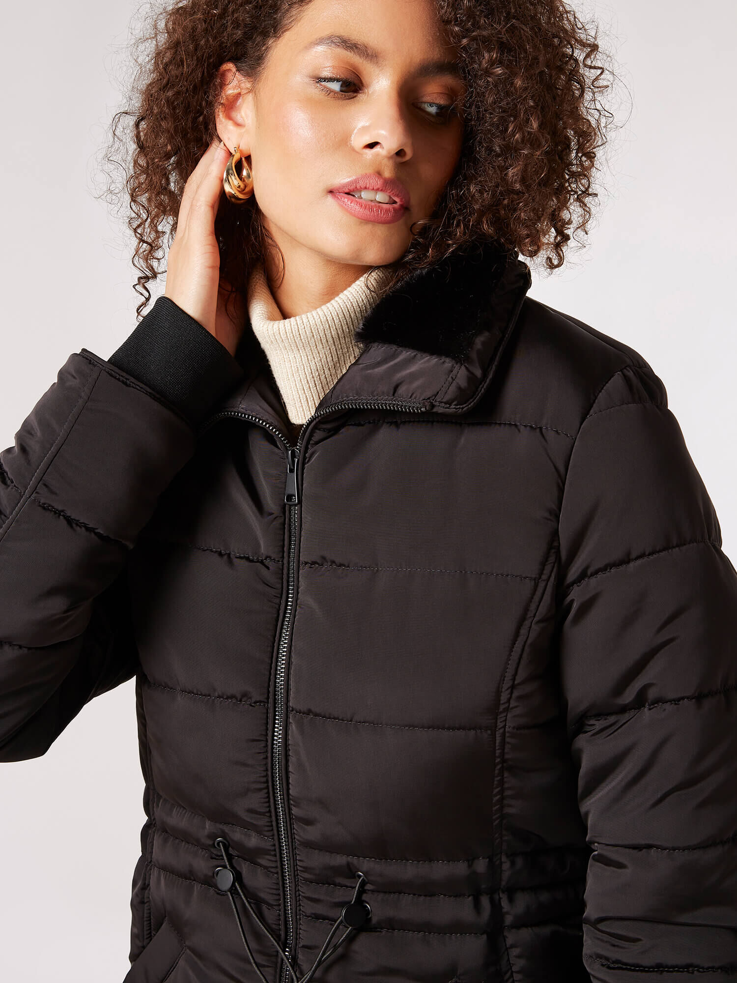 Black puffer jacket with fur hood and belt clearance