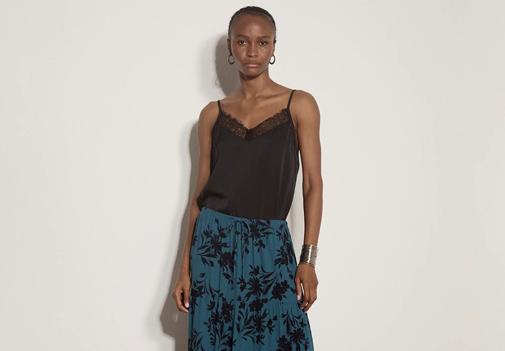 Model wearing the BLACK LACE CAMI TOP