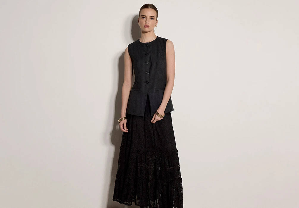 Model wearing the black Cotton-Blend Lace Tiered Midi Skirt