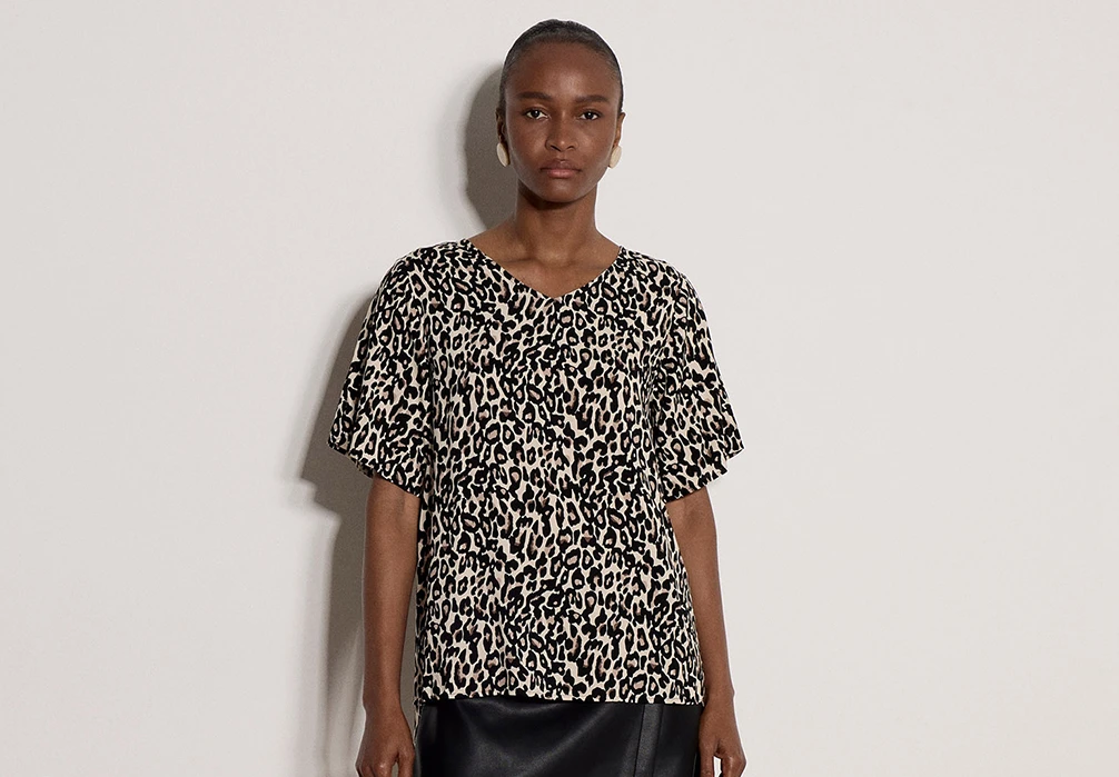 Model is wearing a Button Back Animal Print Woven T-Shirt