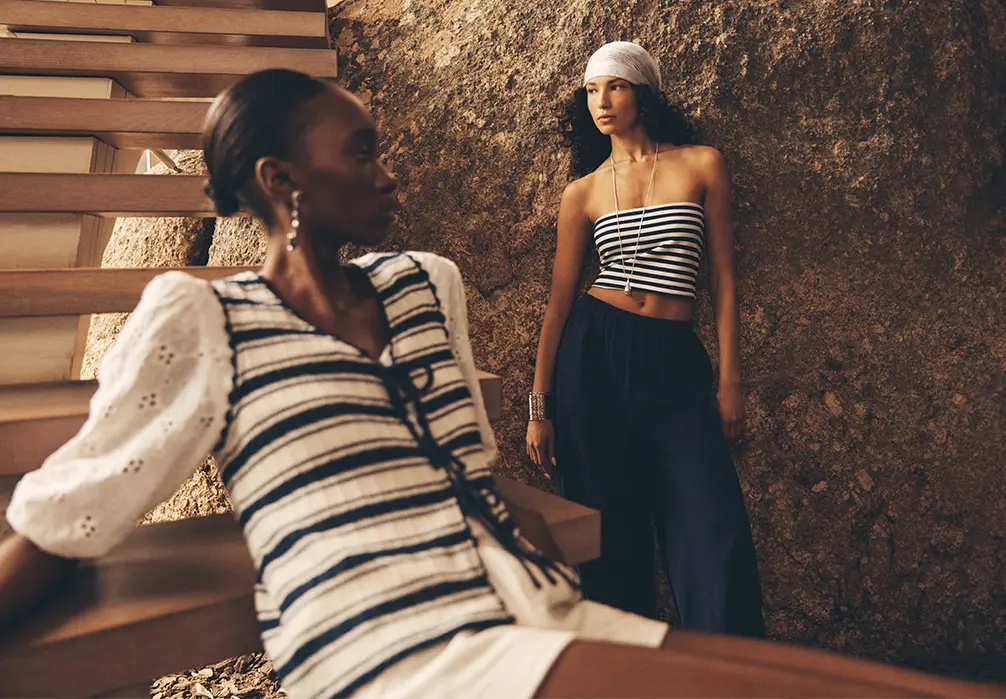 Models are wearing black and white tripe tops