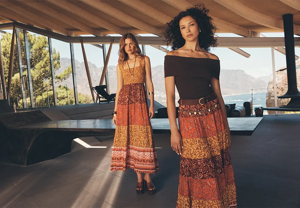 2 Models in a large room with the up front wearing the Patchwork Print Tiered Maxi Skirt
