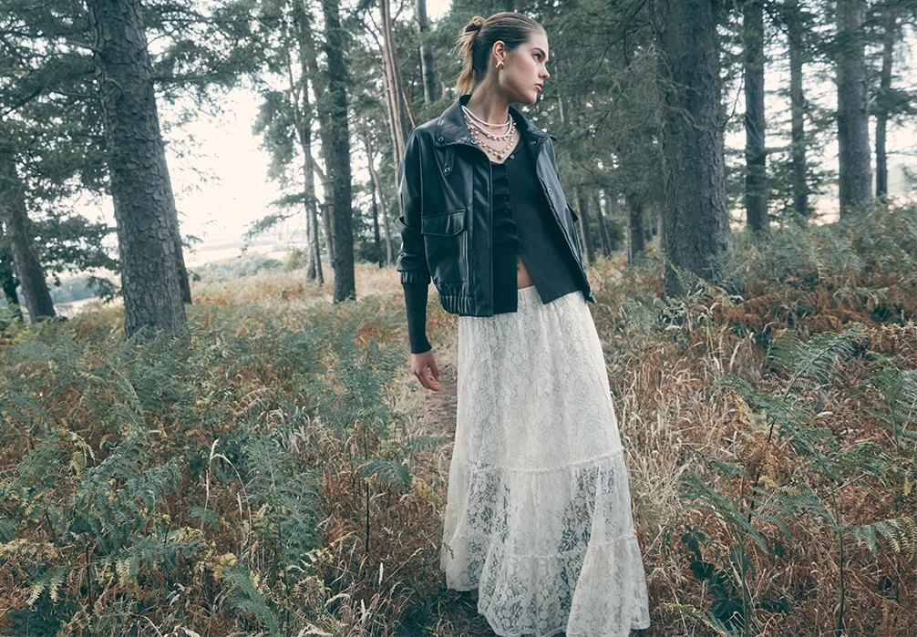Model wearing a cream Cotton-Blend Lace Tiered Midi Skirt